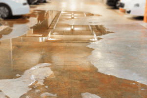 A garage floor overflowed because of clogged floor drains