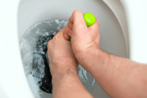 Removing clogged materials with a hand plunger