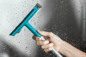 Using a shower squeegee for preventing mold growth